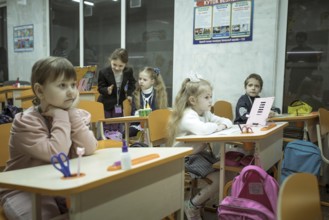 Pupils in a classroom in one of the metro schools in Kharkiv. Classrooms were set up in various