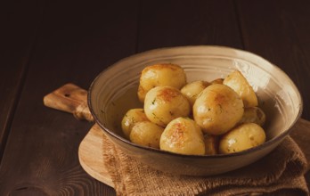 Fresh Cooked, new potatoes, with dill, on a wooden table, selective focus. close-up, toning, no