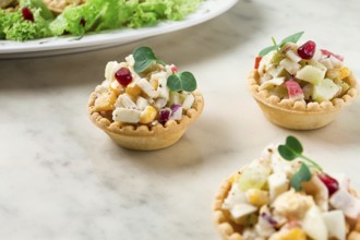 Canapes with salad, corn with crab sticks, appetizer, portioned, close-up, no people