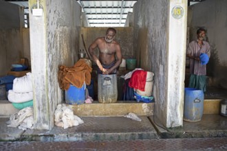 Indian men washing clothes at the Dhoby Khana laundry, Kochi, Kerala, India, Asia