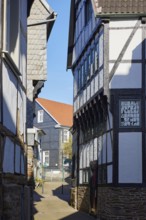 Narrow passageway between half-timbered houses in the historic centre of Hattingen, Ennepe-Ruhr