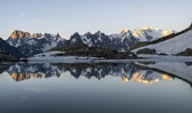 Morning atmosphere, mountain landscape at sunrise, water reflection in Lac Blanc, mountain peak,