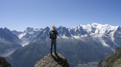 Mountaineer standing on a rock, mountain landscape with mountain peaks Grandes Jorasses, Aiguille