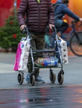 Man with rollator buys 2 large packs of toilet paper, The city centre of Bochum, on the day of the