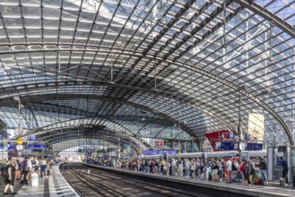 Central station with glass roof construction, crowds of people on the platform, Berlin, Germany,