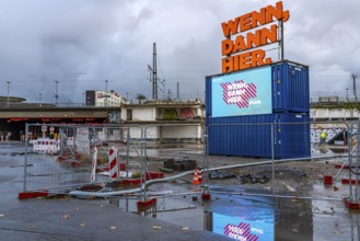 Central station, construction site for a new building, illuminated advertising, neon sign, digital