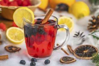 Punch with raspberries, blueberries, lemon and cinnamon, Christmas atmosphere