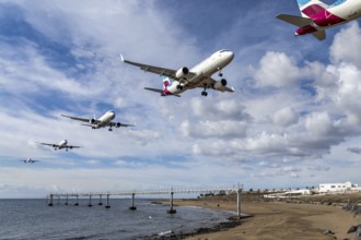 Sequence approach to Lanzarote Airport over beach under cloudy sky, Canary Islands, Lanzarote,