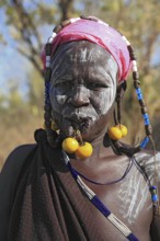 South Ethiopia, in Maco National Park, Mursi tribe, Mursi woman with painted skin and earrings,