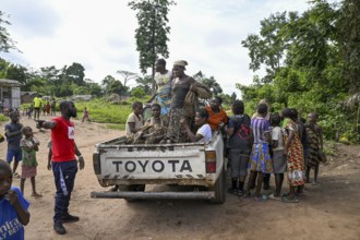 Pygmies of the Baka or BaAka people with their hunting nets on a pick-up truck, Bayanga,