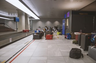 Many lost suitcases and pieces of luggage are ready for collection at an airport