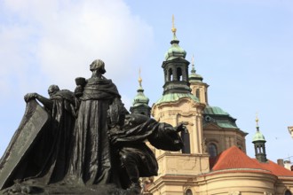 Jan Hus Monument on Old Town Square and the baroque St Nicholas Church, Prague, Czech Republic,