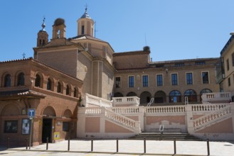 Historic church with stairs and brick façade under a blue sky, Iglesia y ex-convento de San