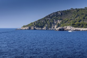 Blue sea and green hills with a sailing boat under a clear sky, Lastovo, Neretva, Croatia, Europe