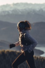 Trail running in autumn on the Jochberg on Lake Walchensee against the wonderful backdrop of the