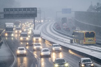 Winter weather, heavy snowfall, traffic jam on the A40 motorway in Essen, local bus, bus lane,