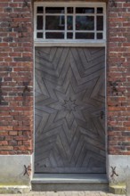 Red brick house façade with old front door, Historische Freiheit Raesfeld, Münsterland, North