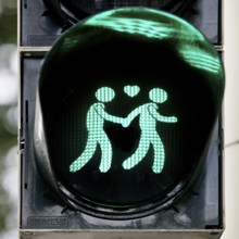 Green pedestrian traffic light with two men and heart, male traffic light couple, homosexual love,