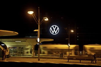 Wolfsburg main station at night with illuminated VW logo at the Volkswagen AG main plant, Lower