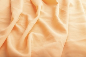 Fragment of orange linen tissue. Side view, natural textile background and texture. wave concept,