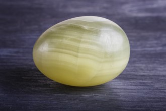 Green onyx egg on a black background, close up