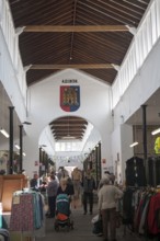 Shoppers inside the historic Shambles market hall in Devizes, Wiltshire, England, United Kingdom,