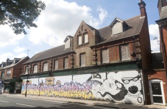 Painted hoarding boards around derelict shop buildings in Upper Orwell Street, Ipswich, Suffolk,