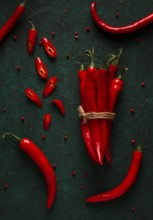 Bunch of red hot chili pepper, close-up, on a dark background, selective focus, no people, concept,