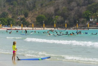 Girl on the beach in a surf school, water sports, beach, sea, ocean, sport, holiday, travel,