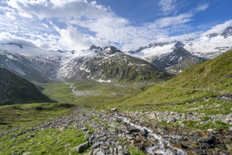 Picturesque mountain landscape with mountain stream, mountain peaks with snow and glacier