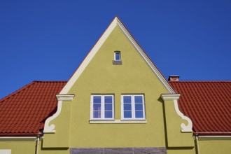 House gable with red tiled roof and white windows against a clear blue sky, Molde, Romsdal, Norway,