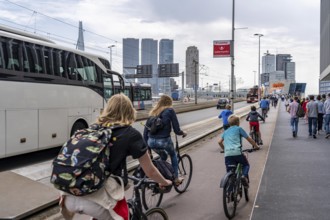 Cyclist on the cycle path of the Erasmus Bridge over the Nieuwe Maas, skyline of the skyscrapers on