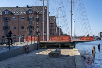 Cyclists on the Cirkelbroen cycle and pedestrian bridge, over the harbour, in the Christianshavens