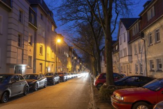 Residential street, many apartment buildings in a residential neighbourhood, evening, lantern