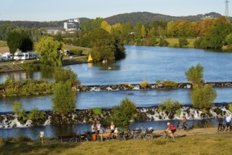 The Ruhr weir, barrage of the Ruhr near Hattingen, cyclist, on the Ruhr Valley cycle path, North