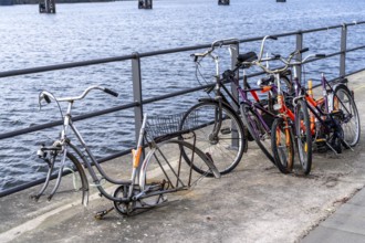 Bicycle scrap, old, partly looted, dismantled bicycles, in the HafenCity in Hamburg, on the shore