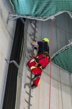 Height rescuers from the Oberhausen professional fire brigade practise abseiling from a wind