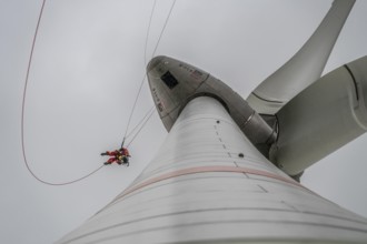 Height rescuers from the Oberhausen fire brigade practise abseiling from a wind turbine from a