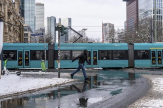 Winter in the city, Gallusanlage street, puddles, pools of water, melt water, pedestrians,