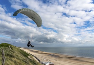 Paragliders along the dunes of Zoutelande, in Zeeland, South Holland, Netherlands