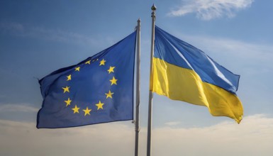 The flags of Ukraine and the European Union, EU, flutter in opposite directions in the wind, AI