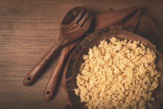 Cooked couscous, in a wooden bowl, top view, no people