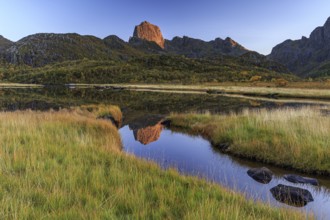 Mountain reflected in lake, autumn, morning light, sunny, Vesteralen, Norway, Europe