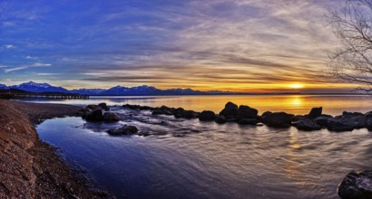 Afternoon sunset with mountains on the horizon and colourful sky over the lake, Chiemsee