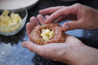 Swabian cuisine, preparation of meatballs in an almond shell, mixed minced meat, raw, meatballs