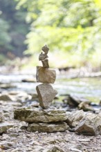 Cairn in perfect balance in a quiet wooded area