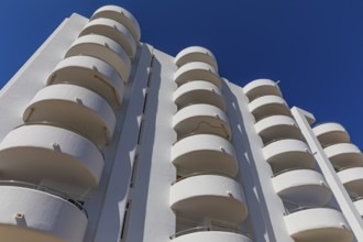 Modern holiday flats with round balconies at the harbour of Santa Eularia, Ibiza, Balearic Islands,