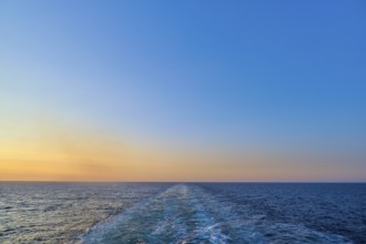 View from the cruise ship at sunset at the stern of the ship onto the stern waves, North Sea,