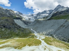 Glacial lake Lac de Chateaupre, lake just below the Moiry glacier, river arms in blue water, aerial