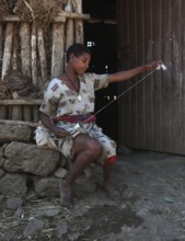 Amhara region, young woman spinning cotton with a spindle, Ethiopia, Africa